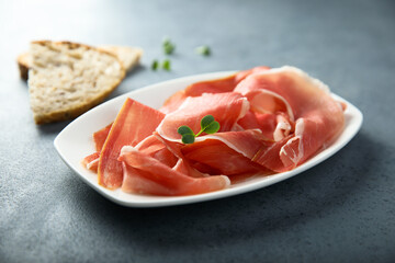 Delicious cured meat on a white plate 