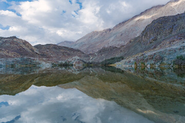 mountains, clouds and sky are reflected on the lake. Beautiful scenery at Yarab Tso valley - Leh Ladakh - India