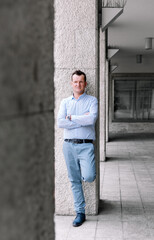 Fototapeta premium Confident business man standing in the city, looking and dreaming of future business success. Business vision. Leadership and successful conceptual strategy