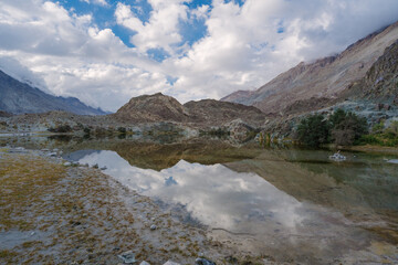 mountains, clouds and sky are  reflected on the lake. Beautiful scenery at Yarab Tso valley - Leh Ladakh - India