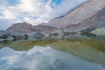 mountains, clouds and sky are  reflected on the lake. Beautiful scenery at Yarab Tso valley - Leh Ladakh - India