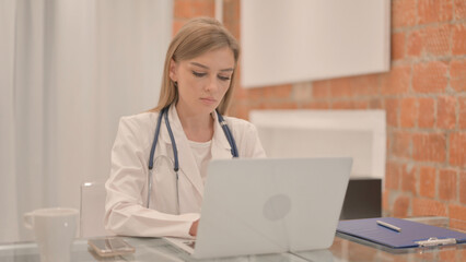 Female Doctor Working on Laptop in Clinic