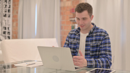 Online Video Chat by Young Casual Man on Laptop 