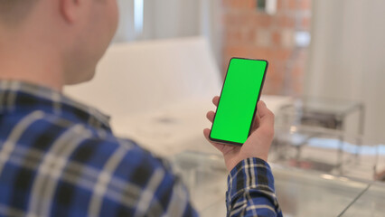 Young Man Using Smartphone with Chroma Key Green Screen