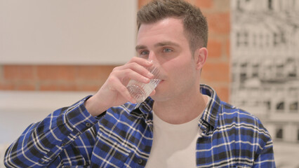 Portrait of Young Man Drinking Water