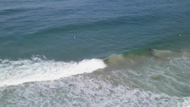 Bodyboarder performs rollo trick and rides through whitewash into barrel, aerial