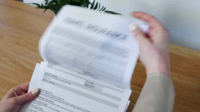 A woman opening a Travel Insurance Document letter outlining her policy and cover details