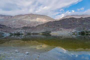 Fototapeta na wymiar mountains, clouds and sky are reflected on the lake. Beautiful scenery at Yarab Tso valley - Leh Ladakh - India