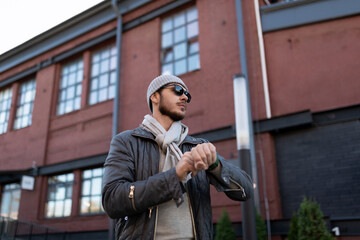 portrait of a european male designer on the background of a dark building