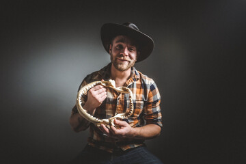 Rugged man in cowboy hat.  Studio session.