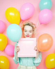 Fototapeta na wymiar Beautiful girl who is happy and excited with bunch of helium balloons, colorful, surprise party on pastel pink background. Generative AI.