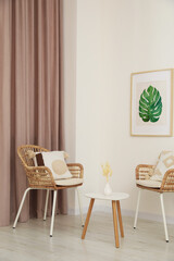 Living room with pastel window curtain, wooden table and rattan chairs