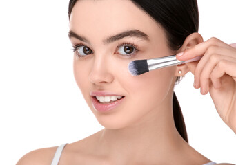 Teenage girl with makeup brush on white background