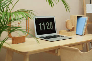 Stylish workplace with laptop, notebooks and houseplant indoors. Interior design