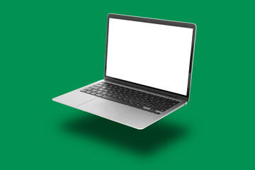 One modern laptop flying on green background