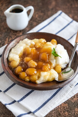 bubur sumsum is Indonesian traditional sweet dessert made by cooking rice flour in coconut milk and served with palm sugar. There is also a variety served with potato dumpling or biji salak.
