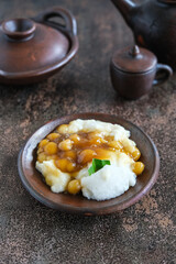 bubur sumsum is Indonesian traditional sweet dessert made by cooking rice flour in coconut milk and served with palm sugar. There is also a variety served with potato dumpling or biji salak.