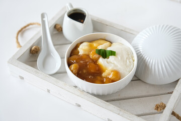 bubur sumsum is Indonesian traditional sweet dessert made by cooking rice flour in coconut milk and served with palm sugar. There is also a variety served with potato dumpling or biji salak.