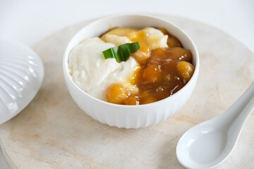 bubur sumsum is Indonesian traditional sweet dessert made by cooking rice flour in coconut milk and served with palm sugar. There is also a variety served with potato dumpling or biji salak.