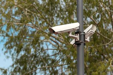 Security cameras mounted on post in public park