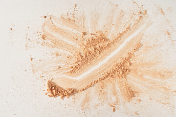 A smear of face powder, on a white background. Minimalistic modern cosmetic scene of bronzer or shadows, top view with space to copy. High quality photo