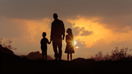 Fototapeta na wymiar silhouettes of a happy family against the sunset