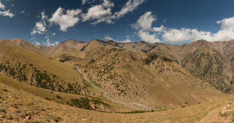 Panoramic view of wild mountain landscape in Turkestan Mountains in Kyrgyzstan.
