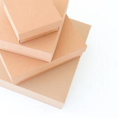 Craft boxes on a white background are stacked on top of each other. Place for text and logo. The concept of packaging, gift, moving.