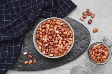 Many dry kidney beans on light grey table, flat lay