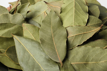 Aromatic bay leaves as background, closeup view