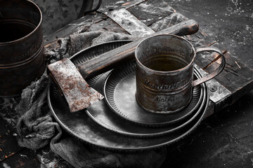 Fototapeta na wymiar Old metal kitchen utensils: plate, mug, kitchen utensils. Top view. Free copy space.