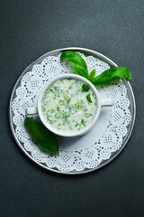 Okroshka cold vegetable soup in a white bowl. Free space for text. Close up.