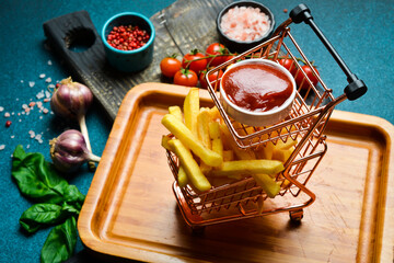 French fries and ketchup sauce. Advertising photo. Free space for text. On a dark background.