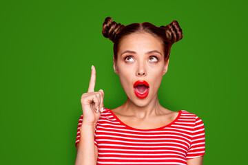 OMG Close up face of attractive astonished brunette girl with modern hairdo having wide open mouth and brown eyes looking up and show isolated fingers up on red background with copy space