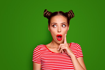 OMG Close up face of shocked astonished girl with modern hairdo having wide open mouth and brown eyes looking at camera and to touch her cheek by finger isolated on red background with copyspace