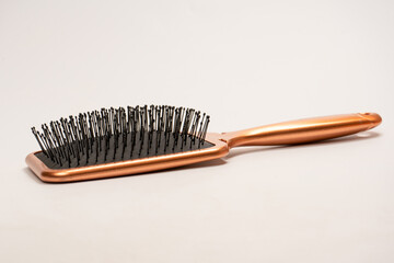 A red hairbrush isolated on a white background. Hair tools.