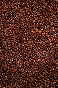 roasted coffee bean background, top view. Macro photo. Free space for text.