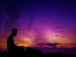 silhouette concept of muslim man praying to allah on hill. with a beautiful natural sunset panorama. focus on people