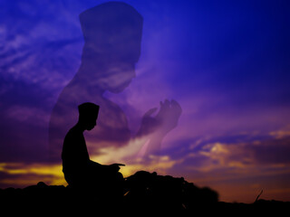 silhouette concept of muslim man praying to allah on hill. with a beautiful natural sunset...