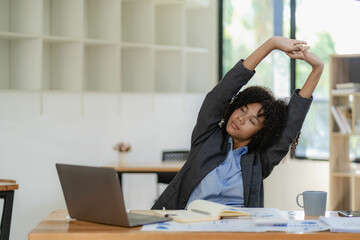 Young african american businesswoman relaxing with hands at office tired employee sitting at desk...