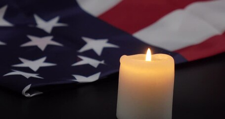 A burning candle on the background of the flag of the United States. Background of grief, memories or celebrations - Powered by Adobe