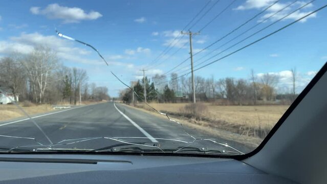 Car Driving on a Road With Cracked Damaged Windshield