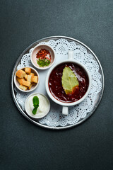 Borsch soup. Beet soup in a white bowl. Free space for text. Close up.