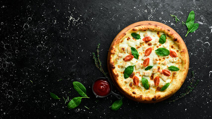 Pizza with chicken, tomatoes and spinach. classic pizza On a black stone background. Top view.