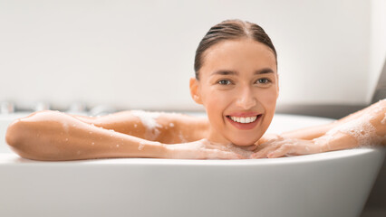Woman Taking Bath Posing In Bathtub Smiling To Camera Indoor
