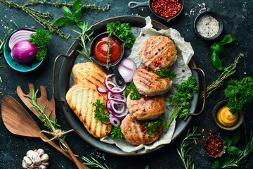 Fried Atriaux - ground pork wrapped in caul fat, swiss cuisine, handmade recipe. On a black stone background. Top view.