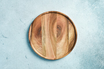 Wooden plate. The dinner plate is made of wood. Top view. on the texture table.