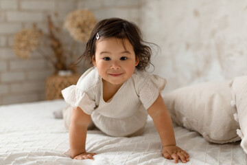 Japanese Toddler Infant Girl Crawling Looking At Camera In Bedroom