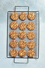Cookies with nuts and chocolate and gray stone background. Top view, space for text.