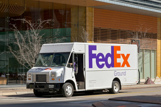 Austin, Texas, USA - February 2023: FedEx truck making a delivery to a building in the city centre